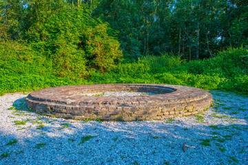 Ruins of an ancient church in a field in wetland in sunlight at sunset in summer, Noordoostpolder, Schokland, Flevoland, Netherlands, August 23, 2021