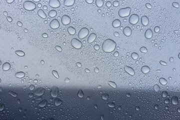 Rain drops on a silver vehicle