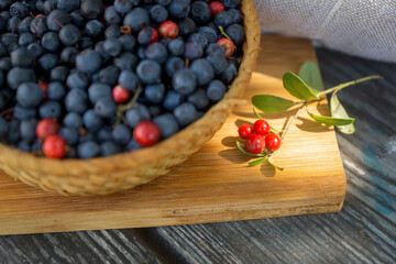 Still life with berries, apples and honey, a holiday at the end of summer, harvesting.