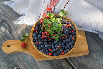 Still life with berries, apples and honey, a holiday at the end of summer, harvesting.