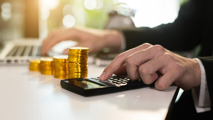 Male Business accountant with calculator save data to Laptop computer financial on office table. concept planning budget and audit. at home office.