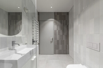 Modern furnished  minimalist bathroom light grey interior design with metro style grey tiles