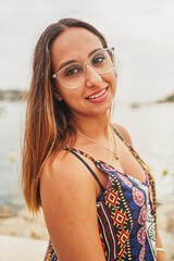 Portrait of young spanish woman smiling to camera in Port d'Andratx