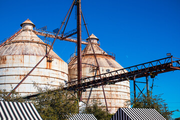 Closeup shot of the top of industrial buildings under the blue sky