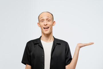Holding a banner on a left hand free place for your text young bald man in black shirt with white...