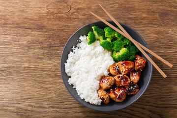 Plate of teriyaki chicken, broccoli and rice, top view