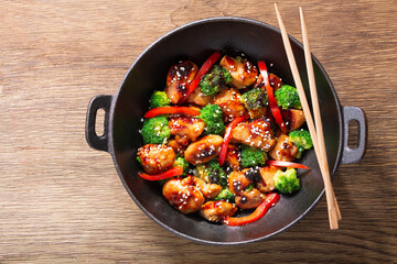 Stir fried chicken with vegetables in a wok