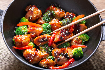 Stir fried chicken with vegetables in a wok