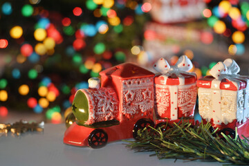 Christmas red train with fir branch and lights on the background