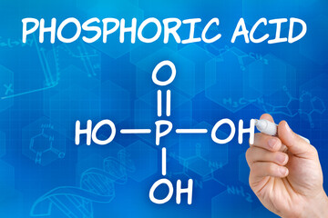 Hand with pen drawing the chemical formula of Phosphoric acid