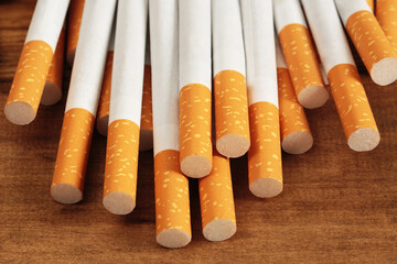 image of several commercially made cigarettes. pile cigarette on wooden. or Non smoking campaign concept, tobacco