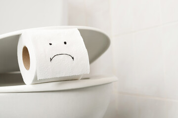 Toilet paper  on the toilet bowl at home.