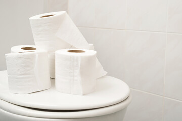 The tissue paper was placed on the toilet bowl in the bathroom.