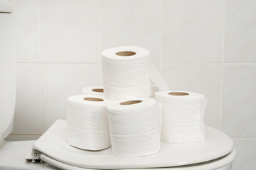 The tissue paper was placed on the toilet bowl in the bathroom.