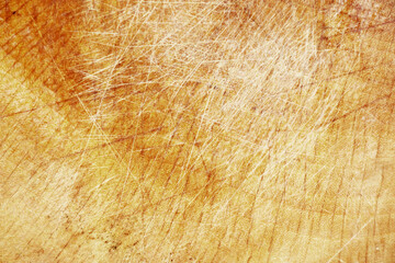 The texture of the brown wood with a dull white scratch fills the frame for the background.