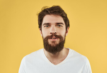 Fototapeta premium handsome man in t-shirt emotions gesture with hands yellow background