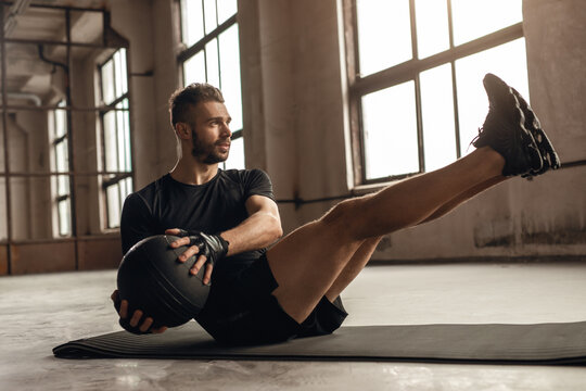 Man doing core exercise with medicine ball