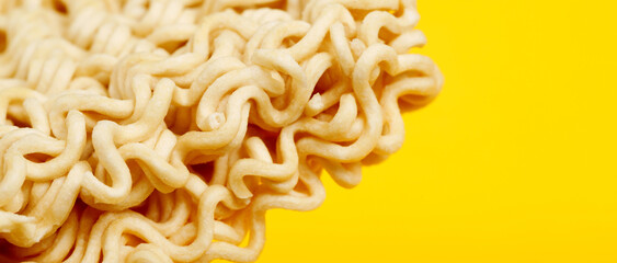 Top view instant noodles on yellow background