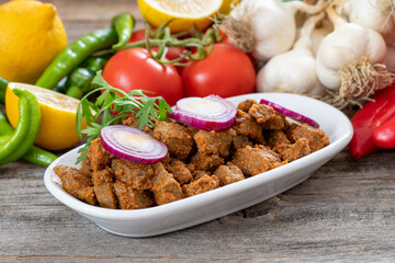 Cooked liver on wood floor. Traditional Turkish appetizer.