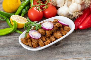 Cooked liver on wood floor. Traditional Turkish appetizer.