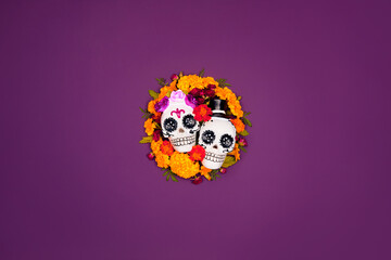 Day of the dead, Dia De Los Muertos, halloween Celebration Background. Sugar Skull, calaverita, marigolds flowers, purple Copy Space. Traditional Mexican culture festival flyer. Flat lay, top view.