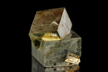 Macro mineral stone Pyrite on a black background