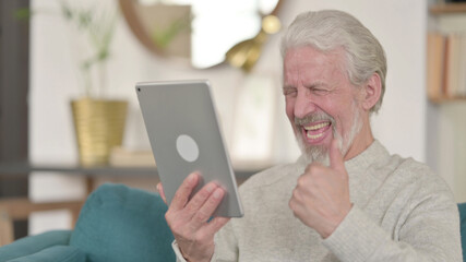 Senior Old Man Celebrating On Tablet at Home