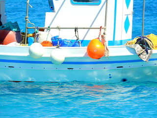 Fototapeta na wymiar fishing boat with turquoise water background in the port of Koufonisia Aegean Cyclades Mediterranean August 25