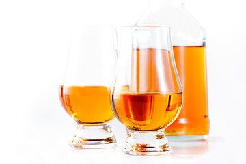 Scotch Whiskey in special glasses and bottle, white background with negative space