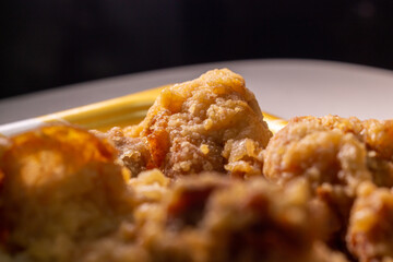 Closeup Japanese style deep fried chicken “Tori no Karaage” packed in plastic tray by local supermarket in Japan. In Japan, Karaage is popular food and widely available throughout country