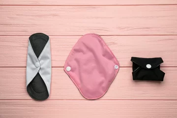Foto op Canvas Many reusable cloth menstrual pads on pink wooden table, flat lay © New Africa