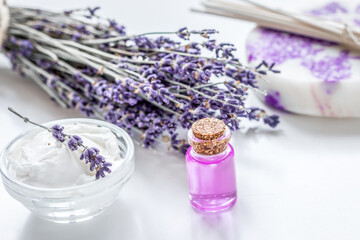 Obraz na płótnie Canvas lavender herbs in body care cosmetics with oil on white table background