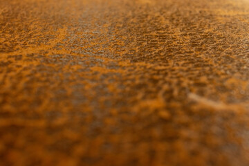 Leather texture peeling over time, with selective focus and brown as the predominant color
