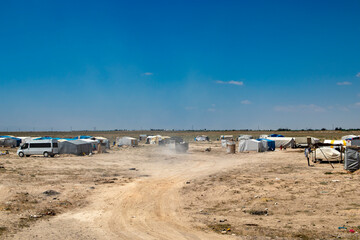 Fototapeta na wymiar migrant tents, refugee camps. seasonal worker tents in an open area.