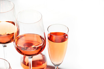 Rose wine glass with bottle on the white table. Rosado, rosato or blush wine tasting in wineshop, bar concept. Copy Space