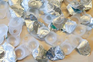 open used plastic contact lens containers on a wooden surface. Vision problems, alternative to...