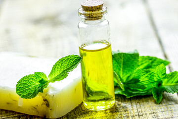 herbal extract in glass bottles and soap for spa on wooden table background