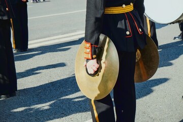 Vintage brass hand cymbals closeup  in hands of musician of military orchestra.Musicians of the military brass band at urban parade.