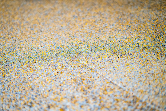Color flake flooring textured background .Close up.Color Flakes make resinous flooring as beautiful as it is practical.Concrete floor,sprinkle with flake stone and smooth.