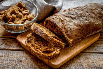 Sliced rye bread on wooden table background