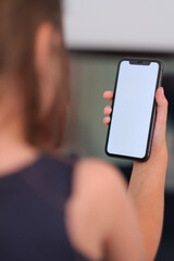 Little girl looking at her phone with white screen