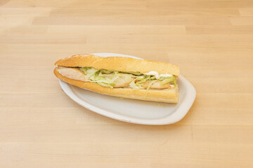 Traditional chicken sandwich with lettuce and mayonnaise on white tray