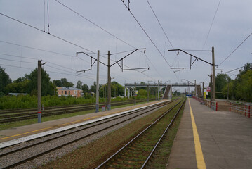 Naklejka premium Railway tracks. Commuter train station. Railway stations