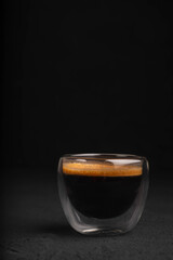 Black coffee in a glass on a dark background