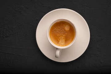Espresso in a white cup on a dark background