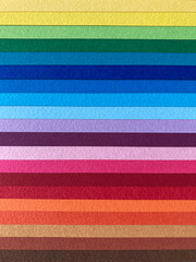 Colorful horizontal rainbow of overlapping paper sheets, abstract striped background