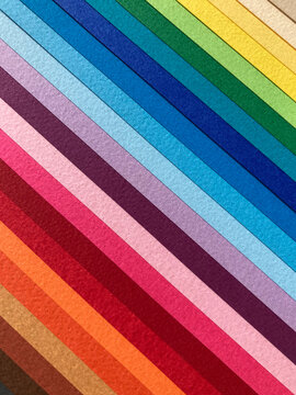 Colorful diagonal rainbow of overlapping paper sheets, abstract striped background