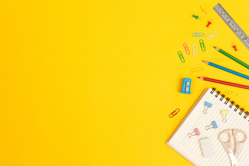 Fototapeta premium Top view notebooks and accessories studying in the library at school yellow background idea education