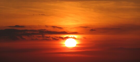 Panoramic view on beautiful fiery orange sunset in the sky