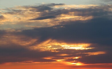 Fiery orange sunset over the dark clouds